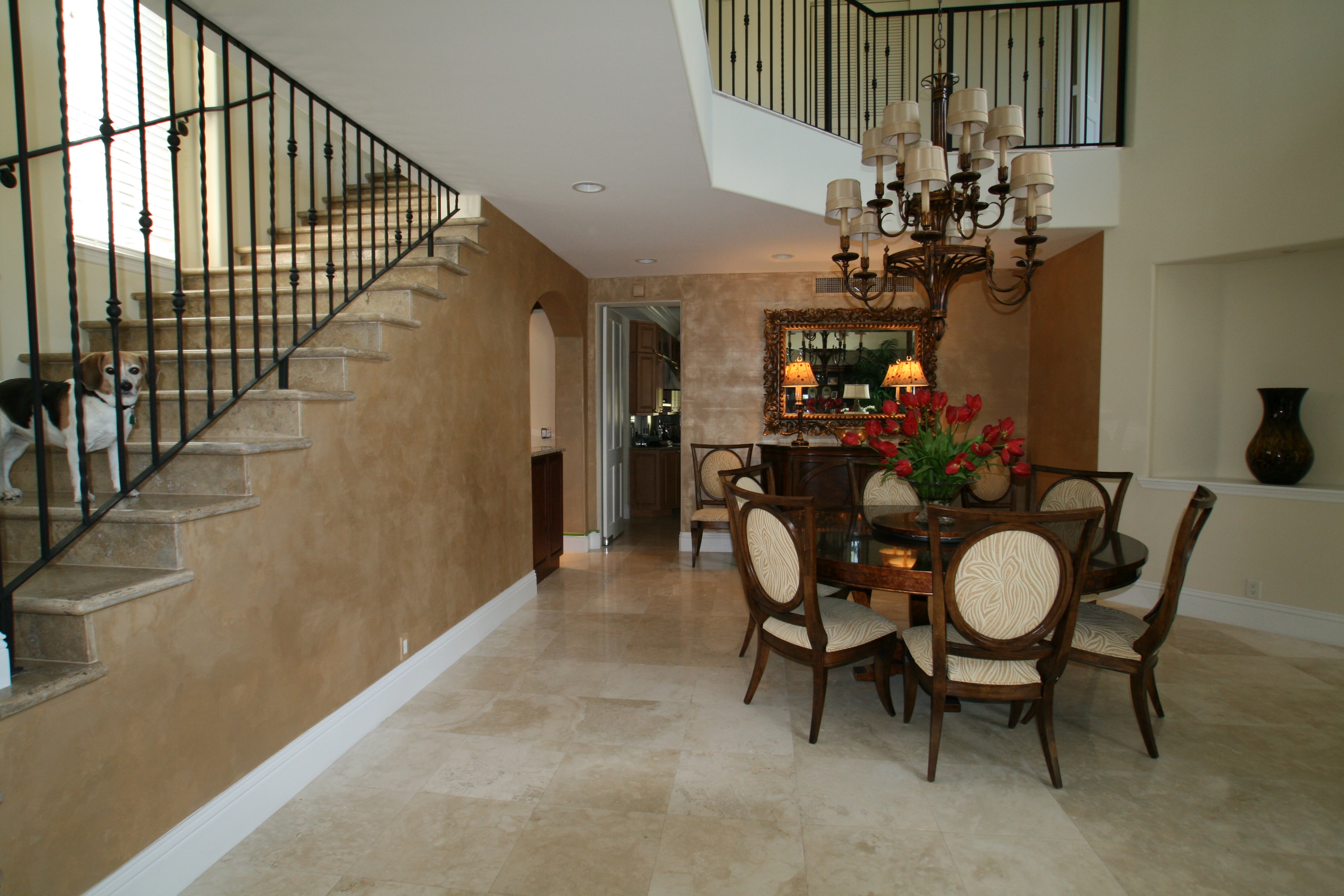 Boynton Beach foyer and dining room with faux finish walls, travertine floors, and chandelier