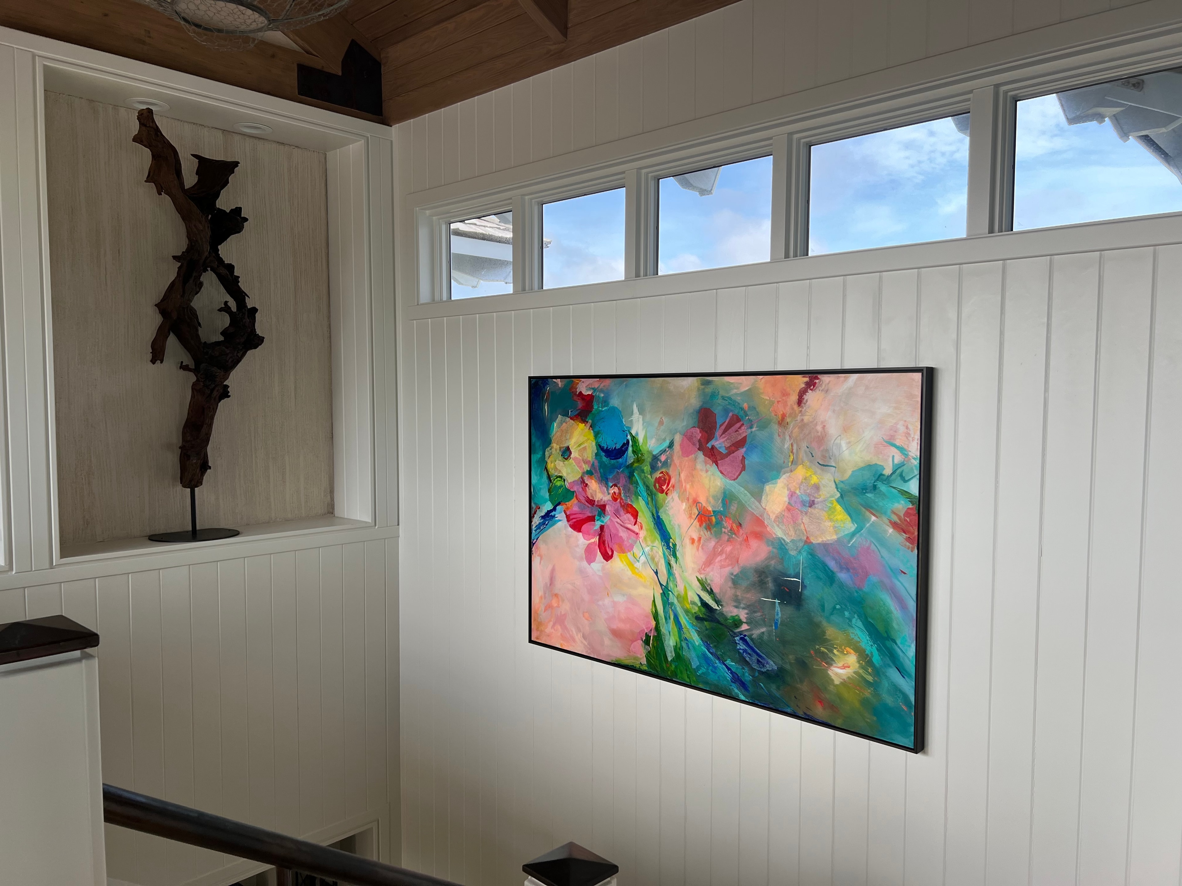 Vibrant abstract floral painting installed on stairwell wall — commissioned painting by Lisa Autry