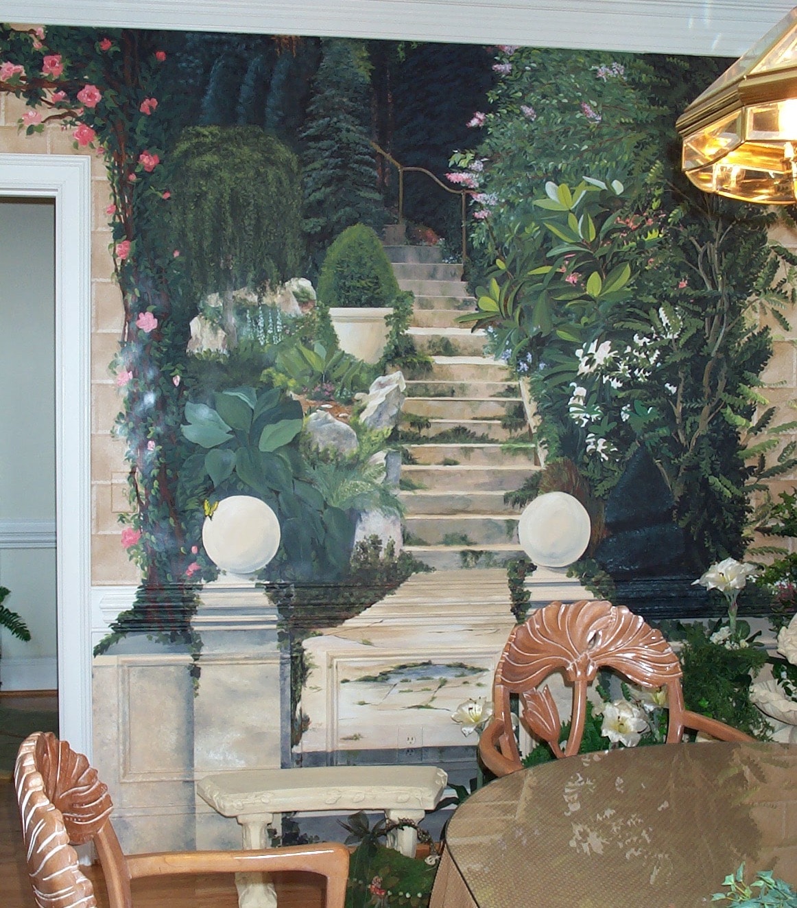Garden room trompe l'oeil mural — stone staircase with lush botanicals, roses and white lilies