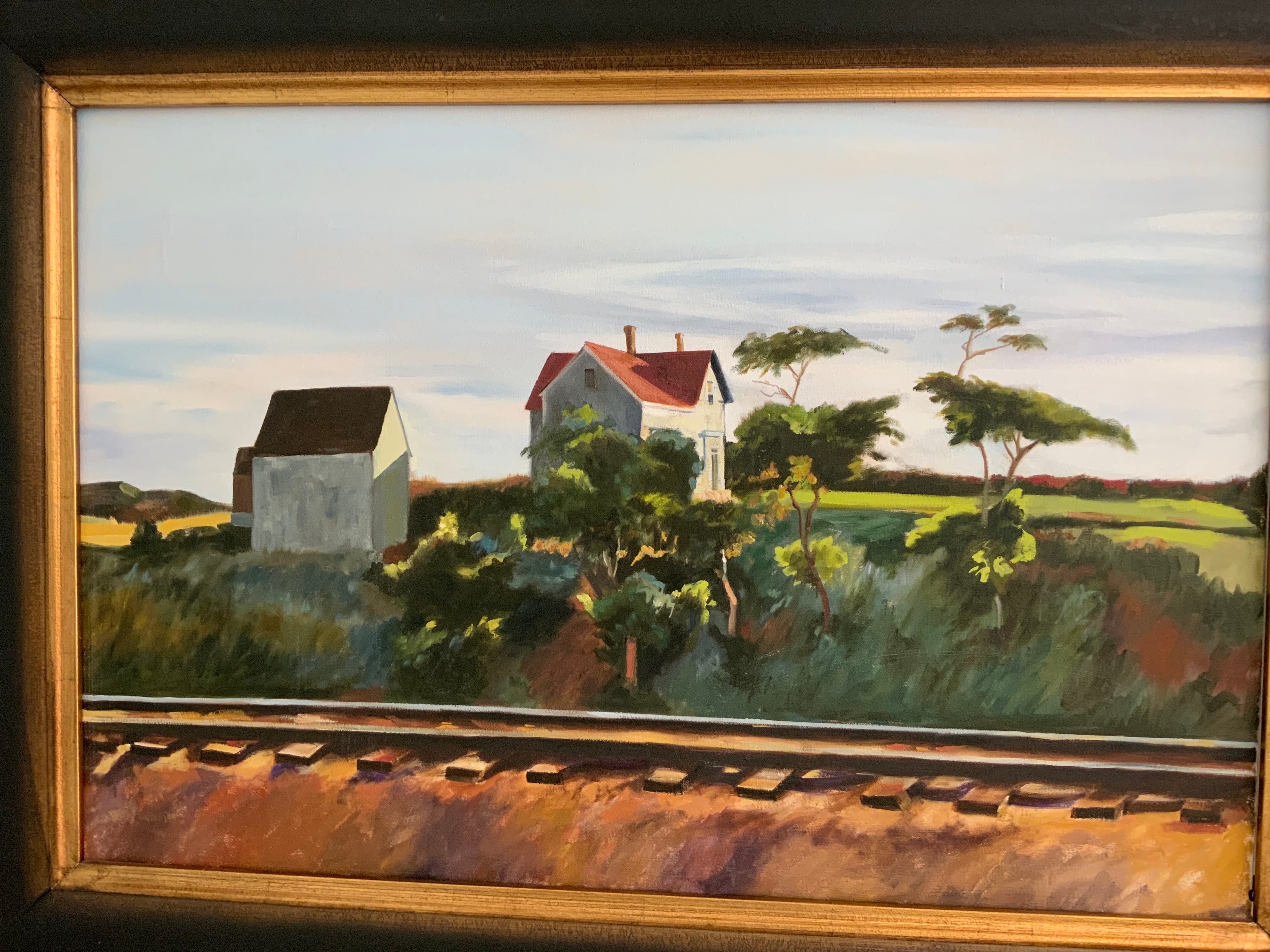 Rural landscape with farmhouse and railroad tracks in gold frame — commissioned painting