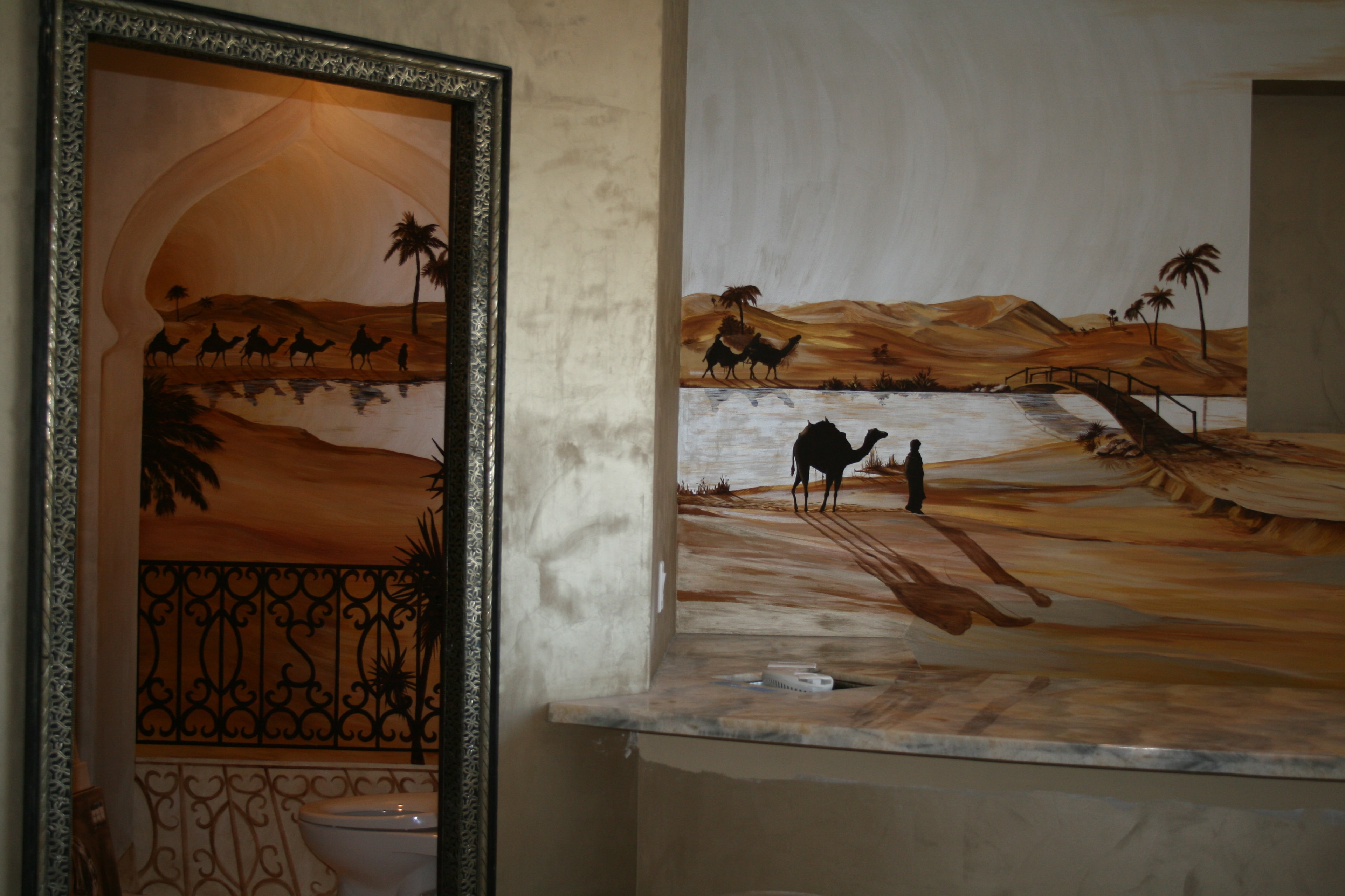 Sahara desert mural — wide room view with Moroccan mirror and camel caravan scene