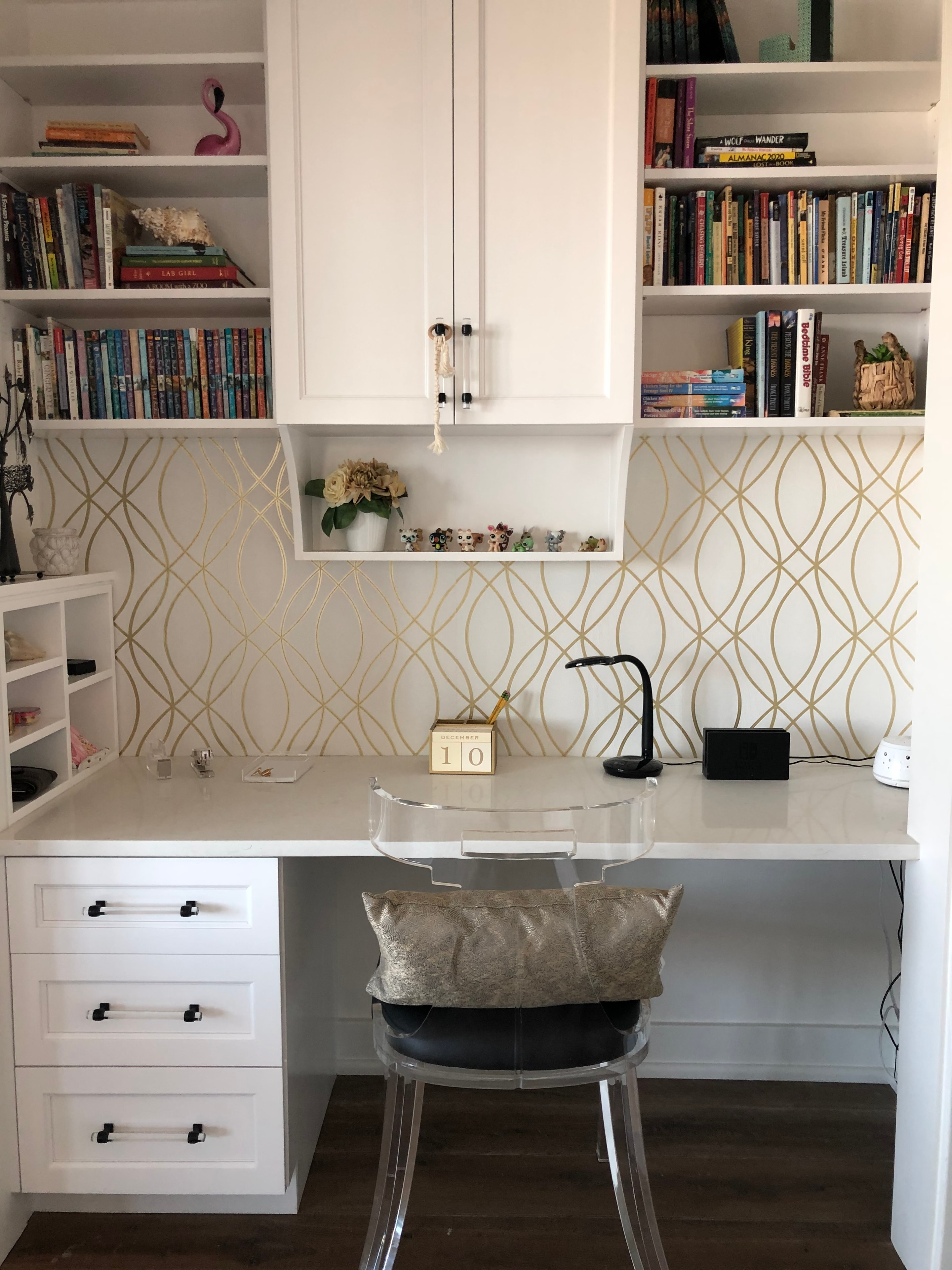 Figure Eight Island — bedroom with built-in arched headboard wall and gold sconces