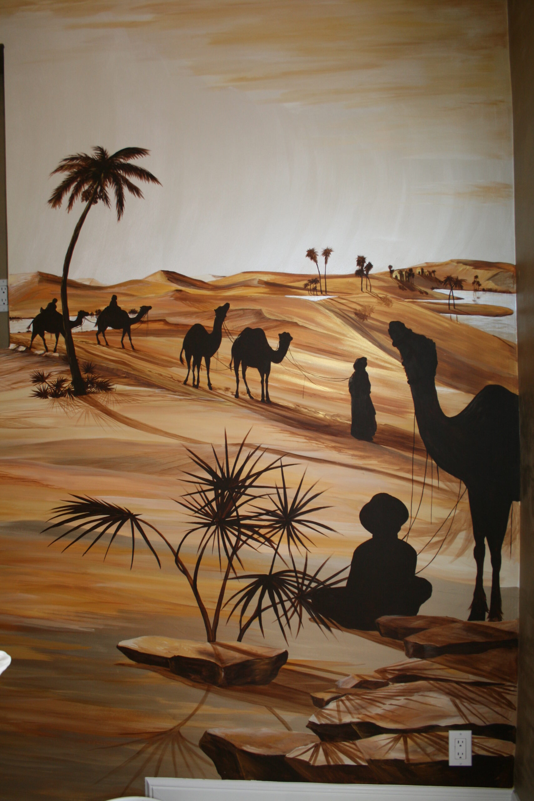 A painting of people and camels in the desert.