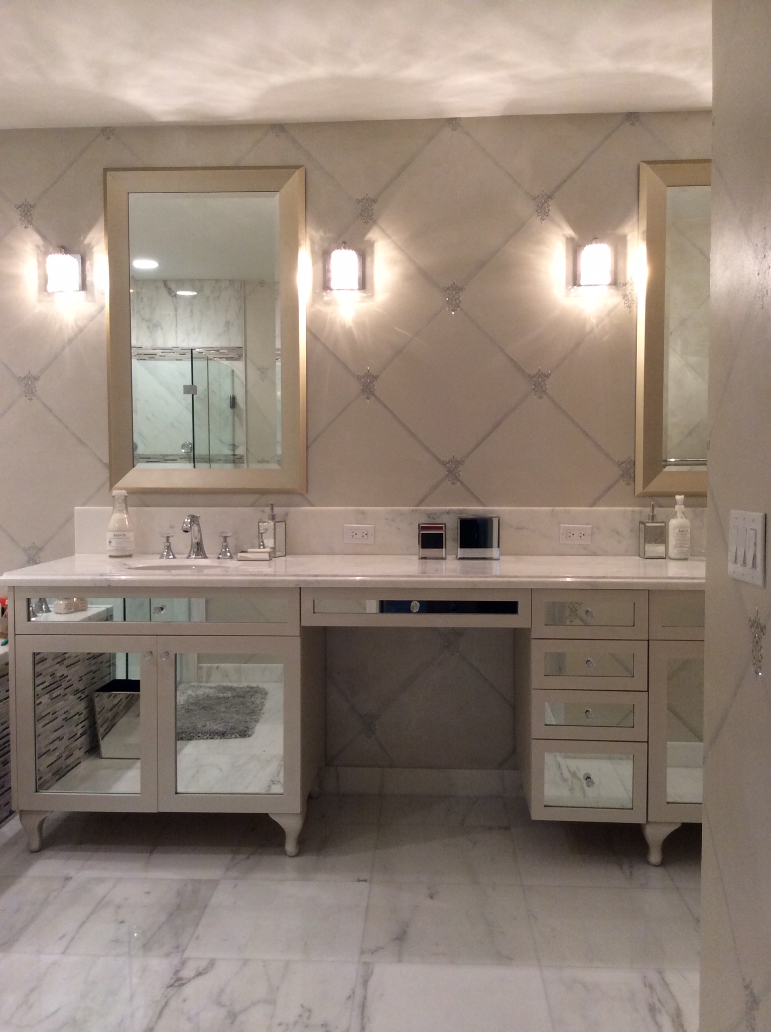 A bathroom with two mirrors and a sink.