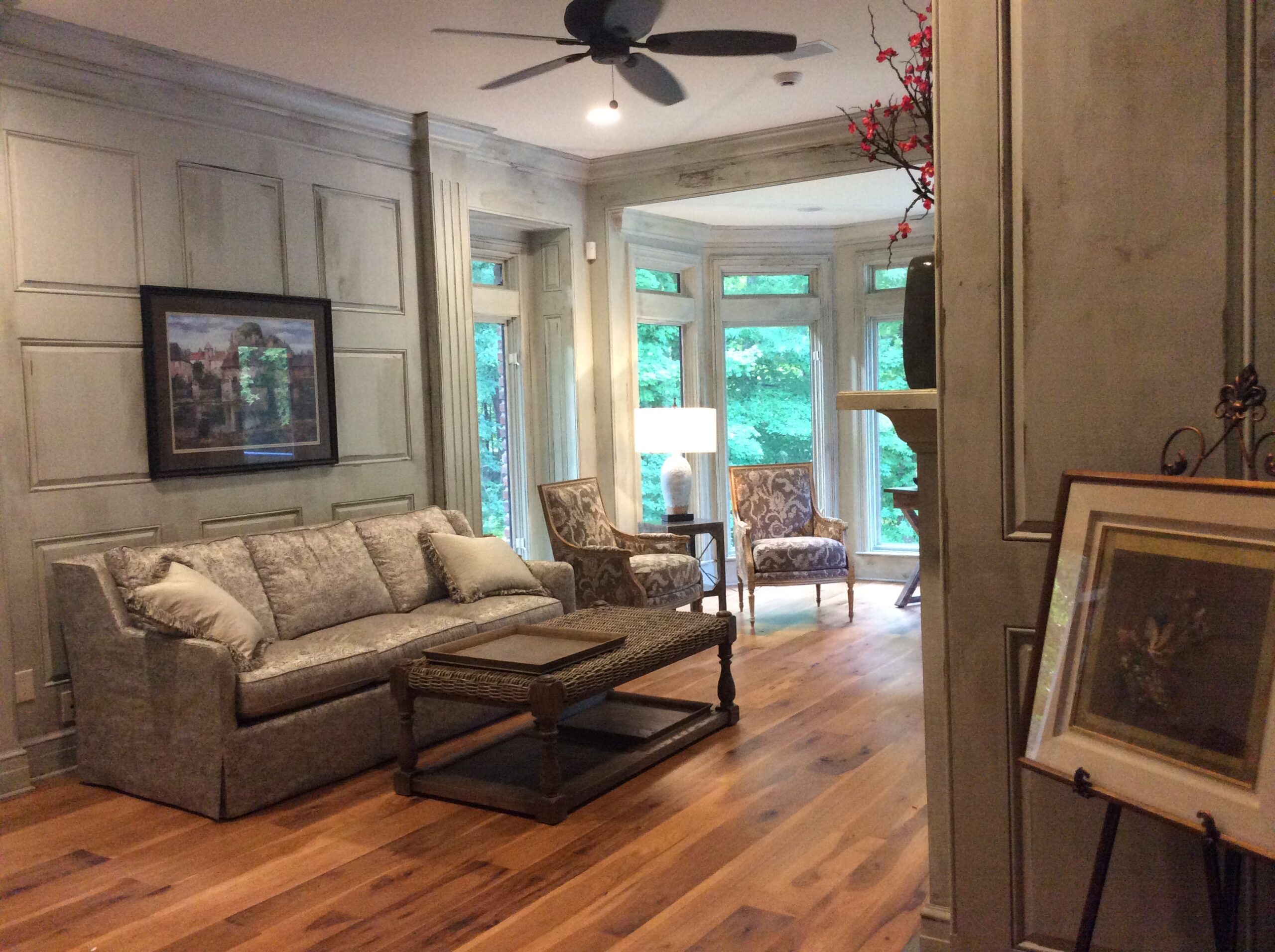 A living room with hard wood floors and furniture.