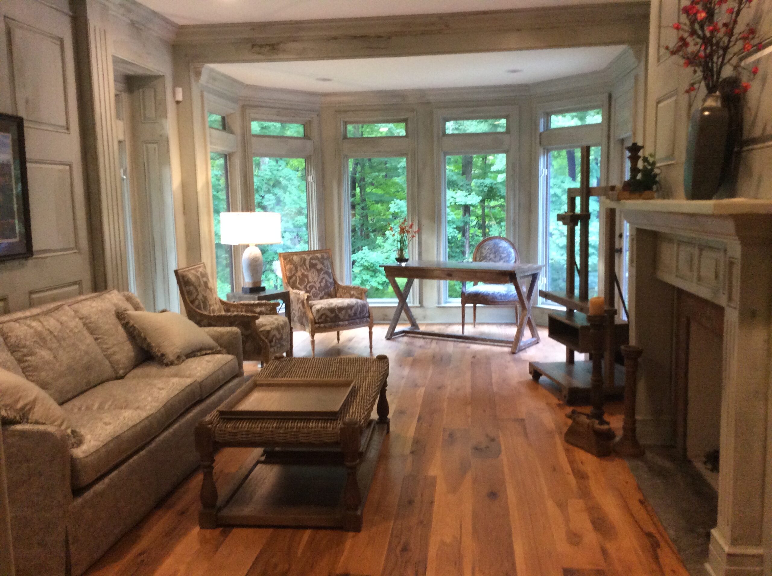 A living room with hard wood floors and furniture.