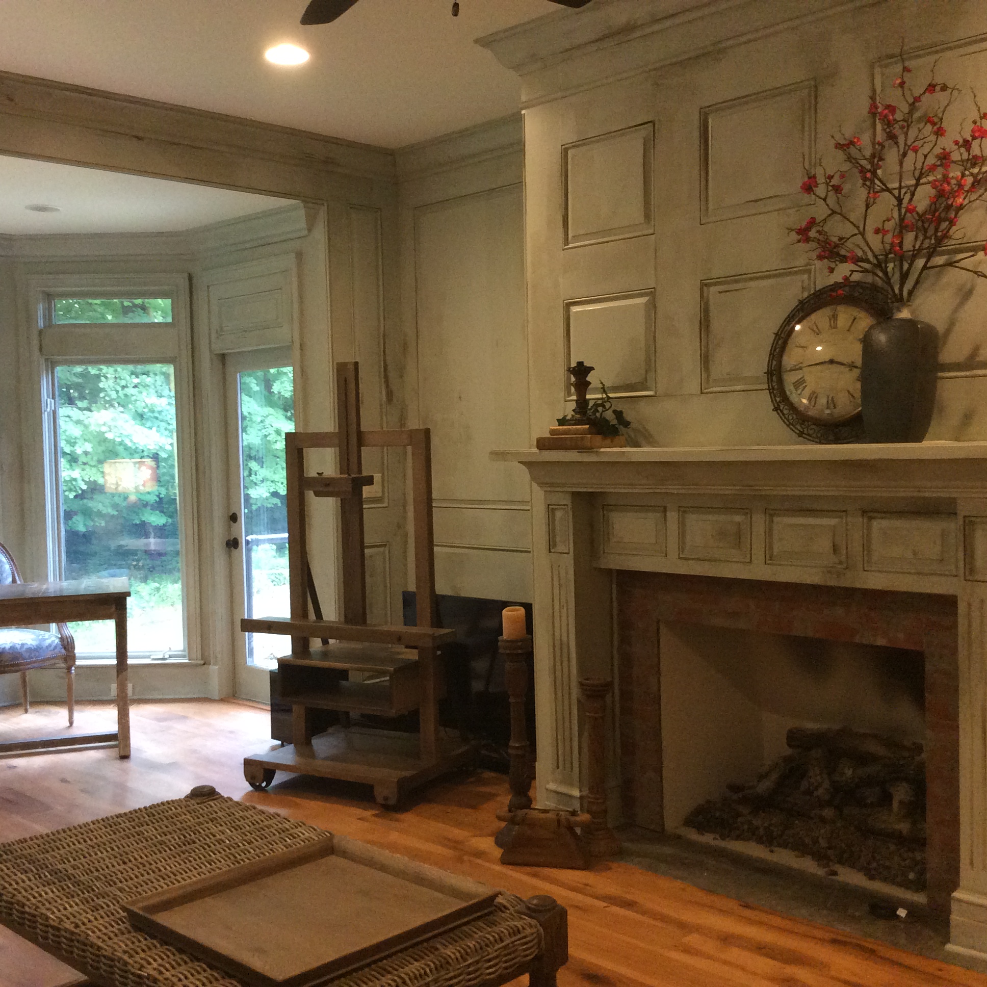 A living room with a fireplace and wooden floors