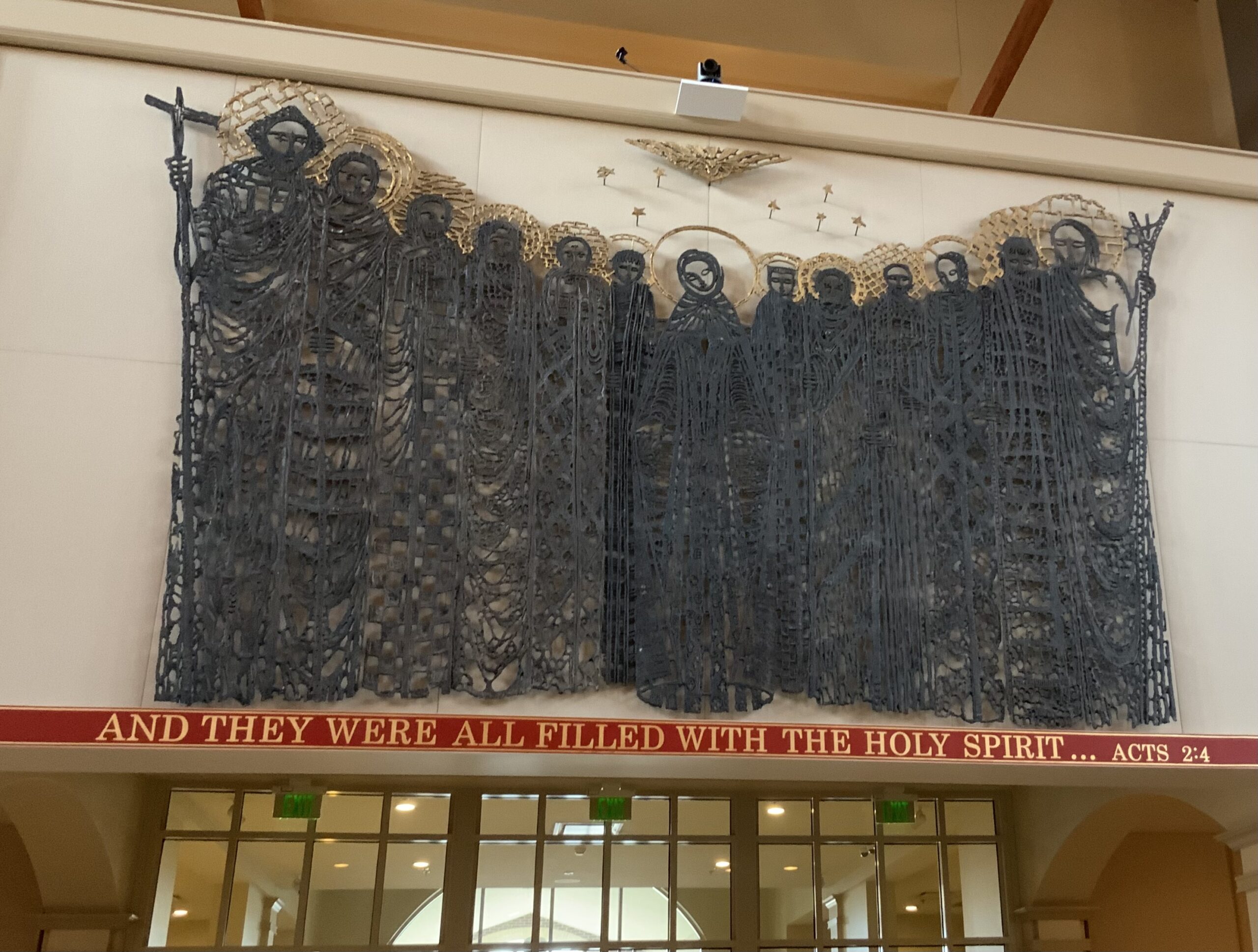 A large wall hanging of people with swords and crosses.