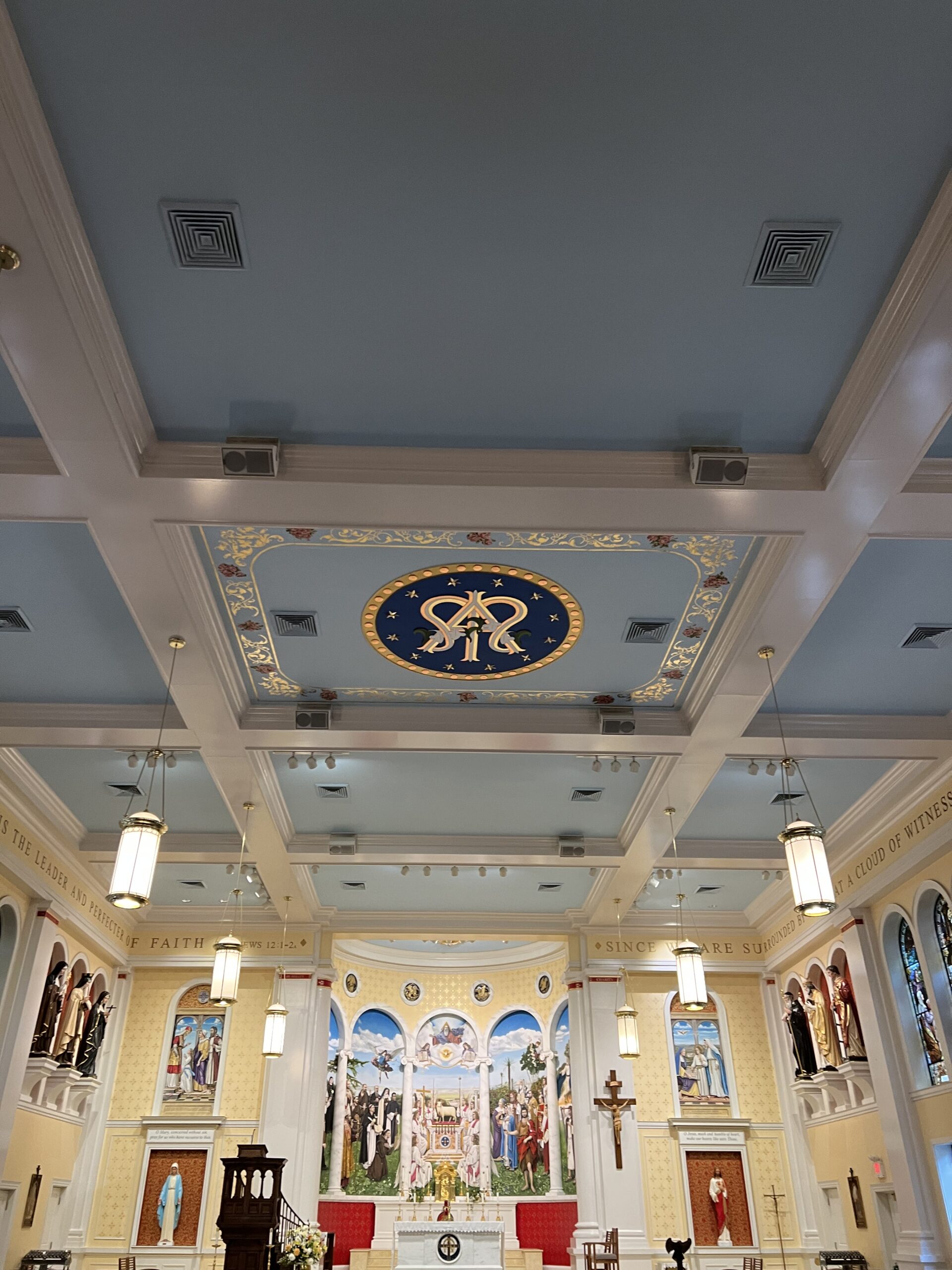 A ceiling with many paintings on it