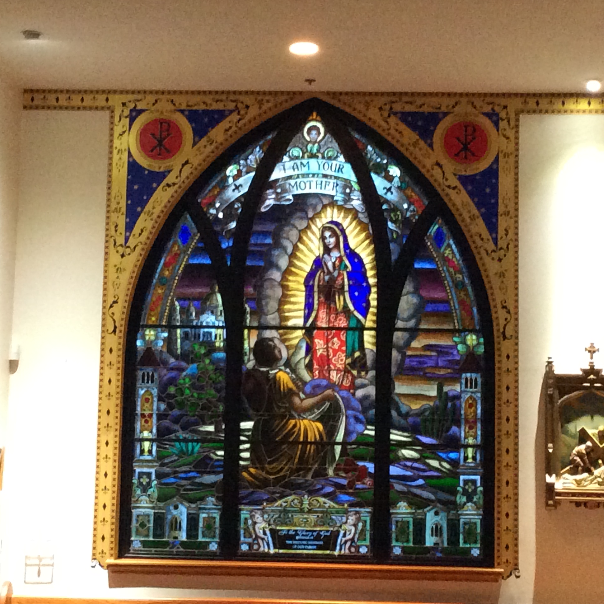 A stained glass window of jesus in the center.