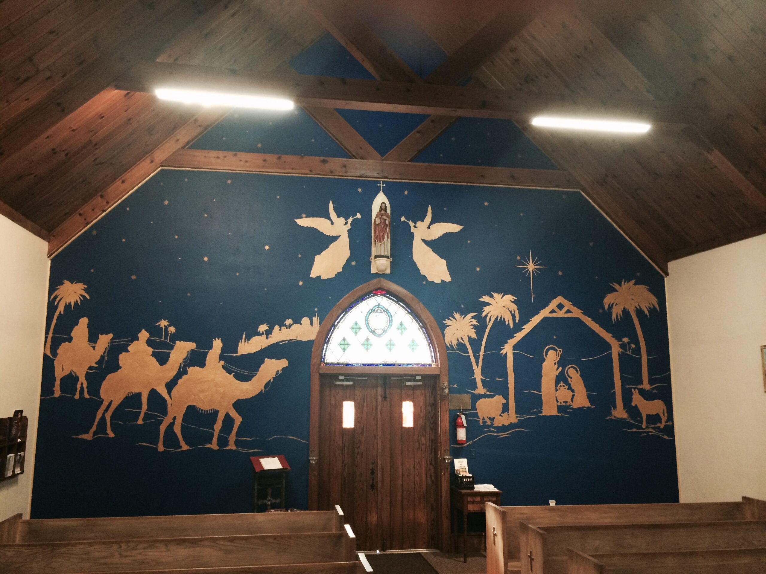 A church with a nativity scene painted on the wall.