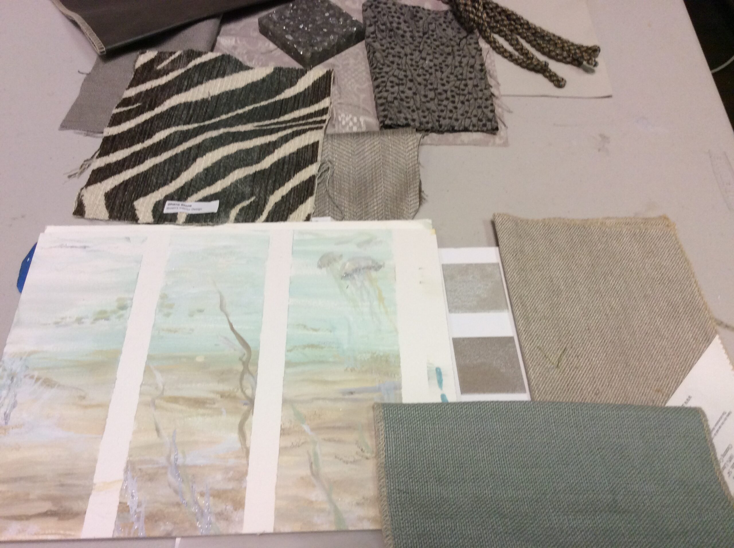 A table with various fabrics and papers on it.