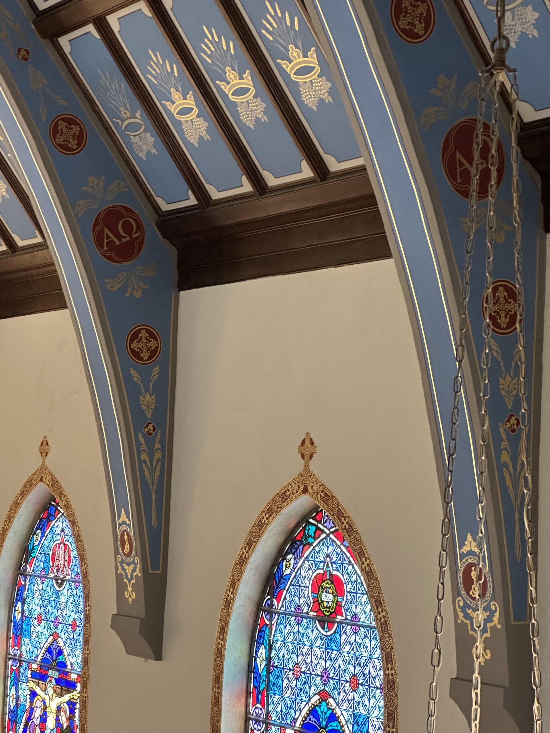 A church with stained glass windows and arches.