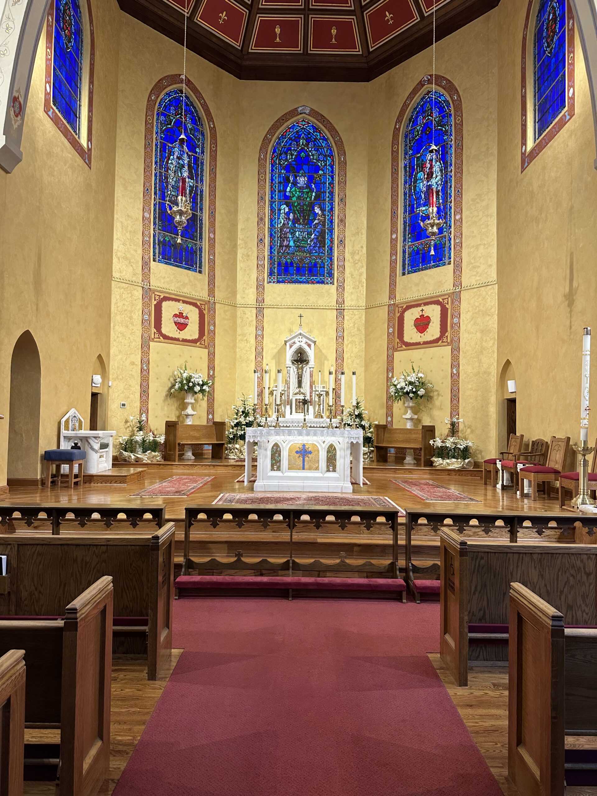 A church with many stained glass windows and a large altar.