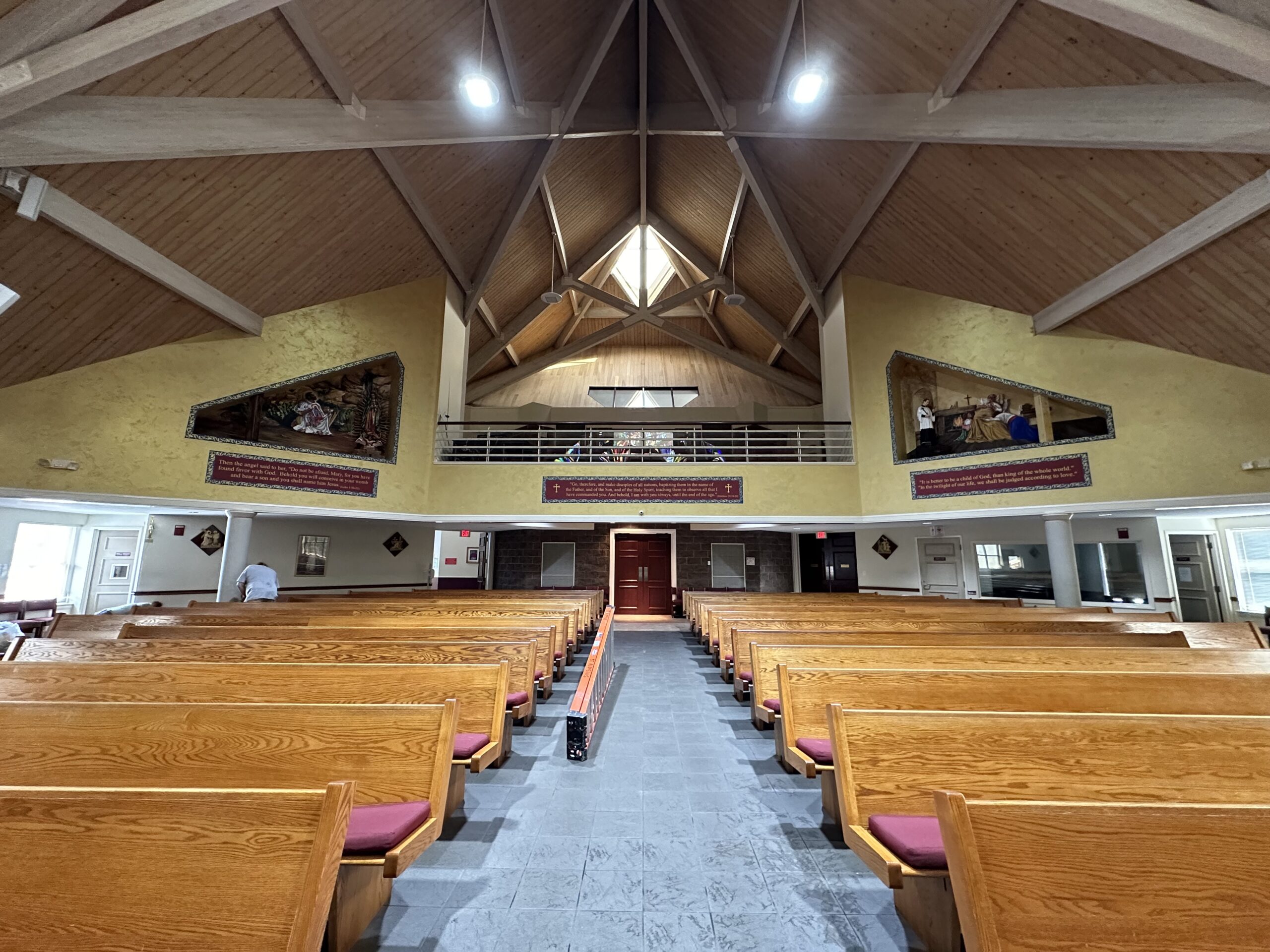 A large church with many wooden pews and a vaulted ceiling.