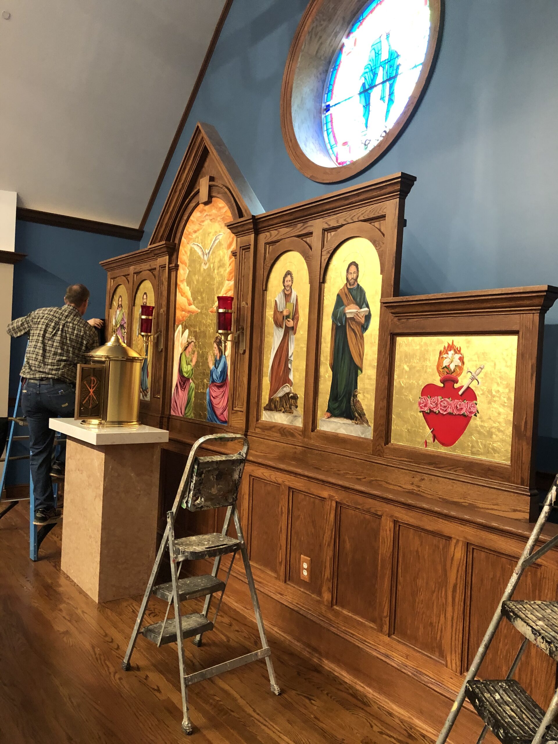 A man standing in front of a wooden alter.