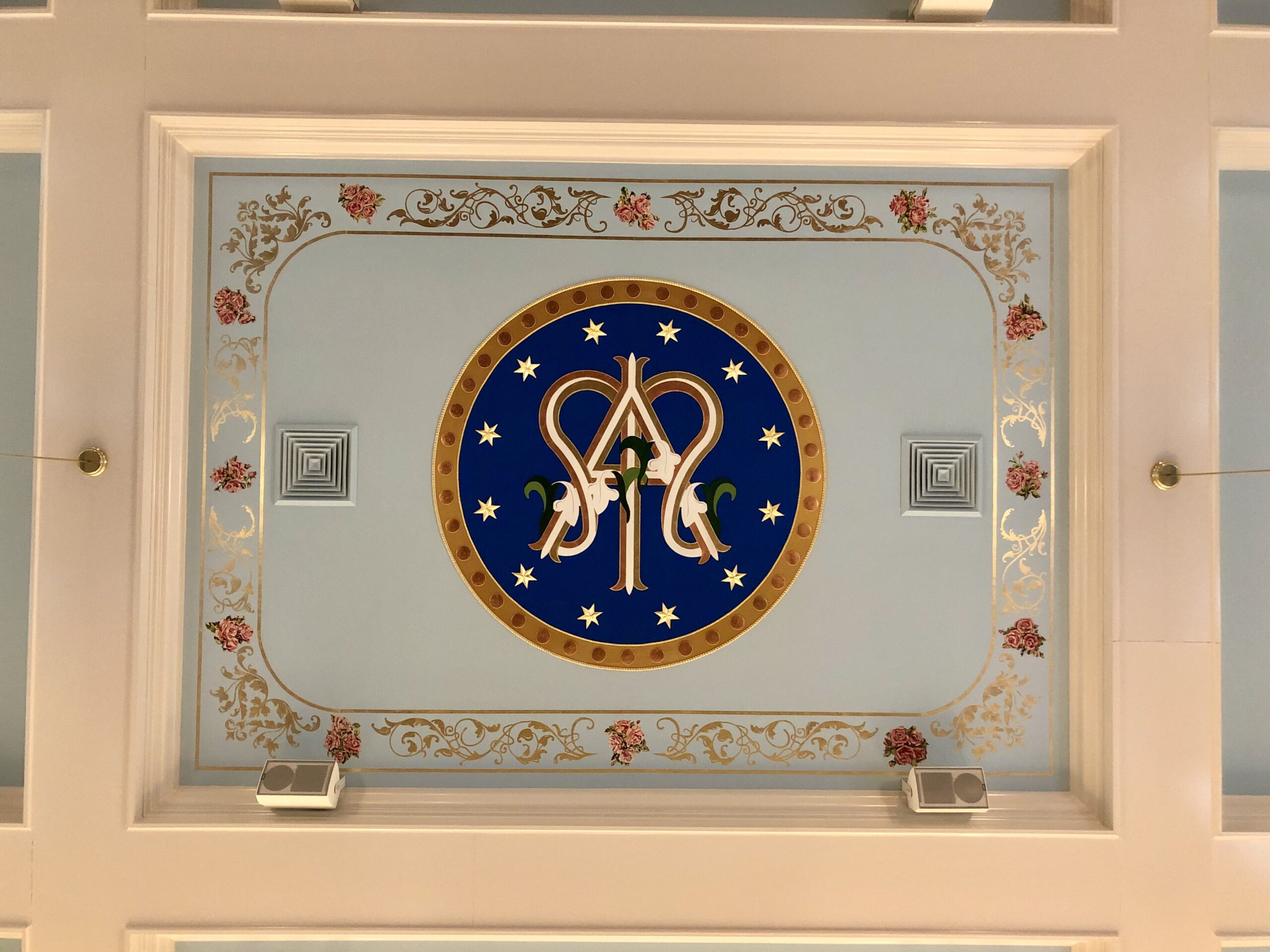 A ceiling with a painting of the symbol for the fraternity.