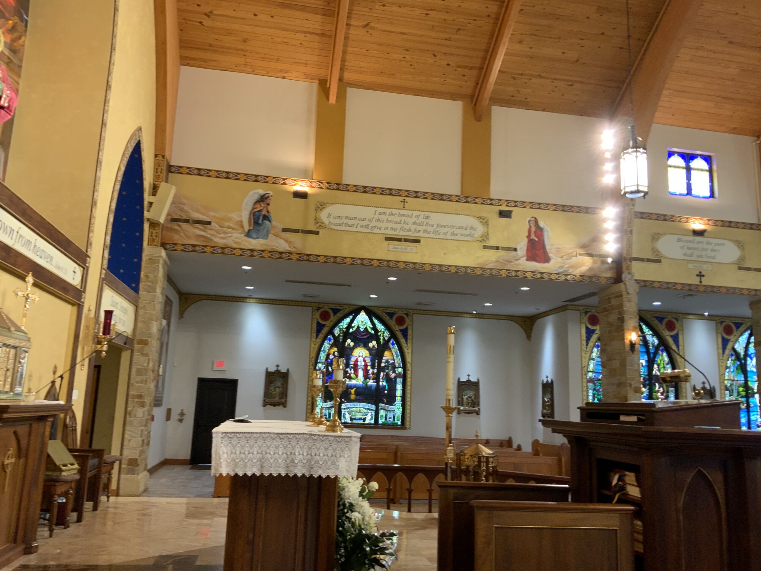 A church with stained glass windows and pews