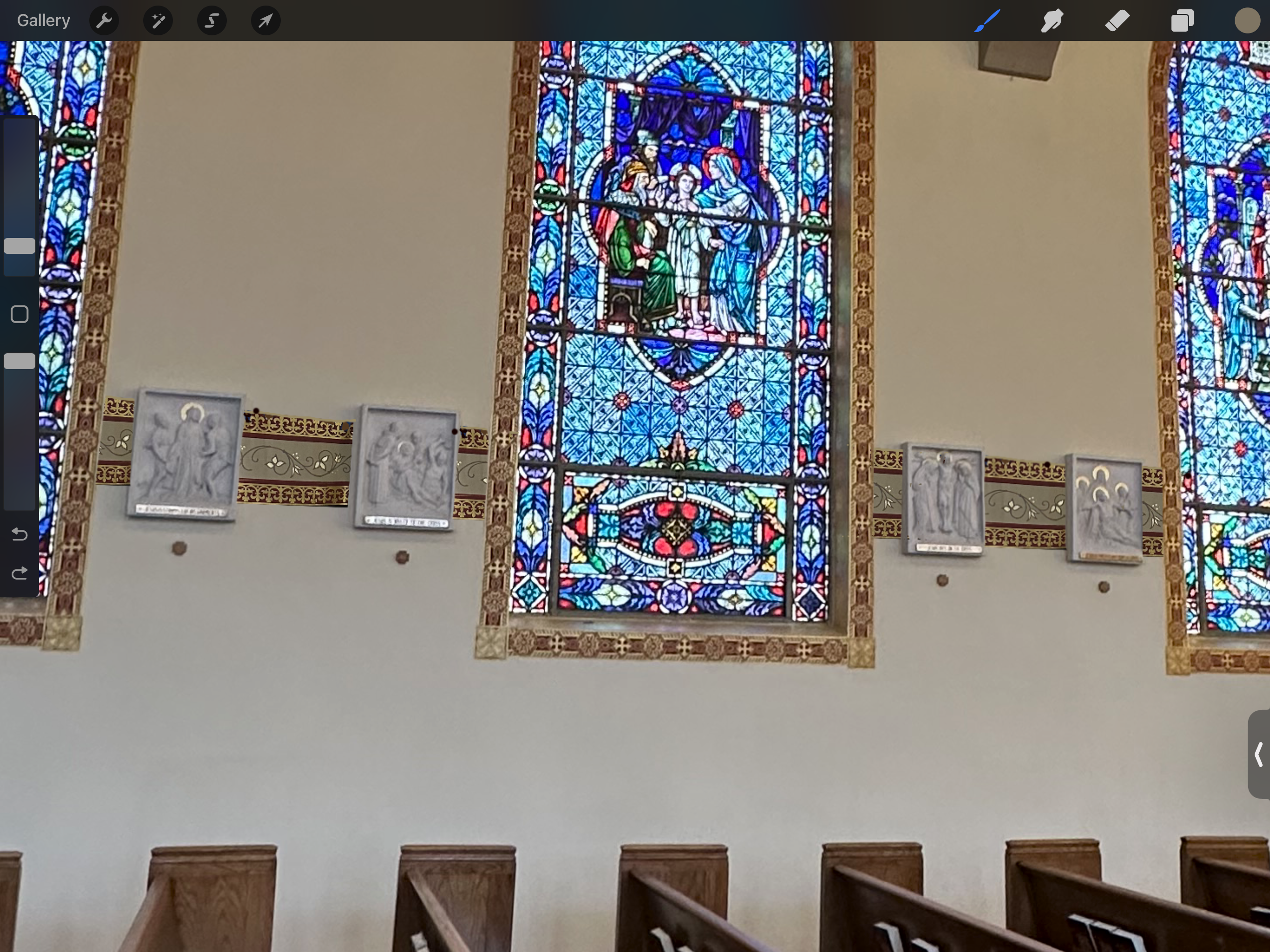 A stained glass window in the middle of a church.