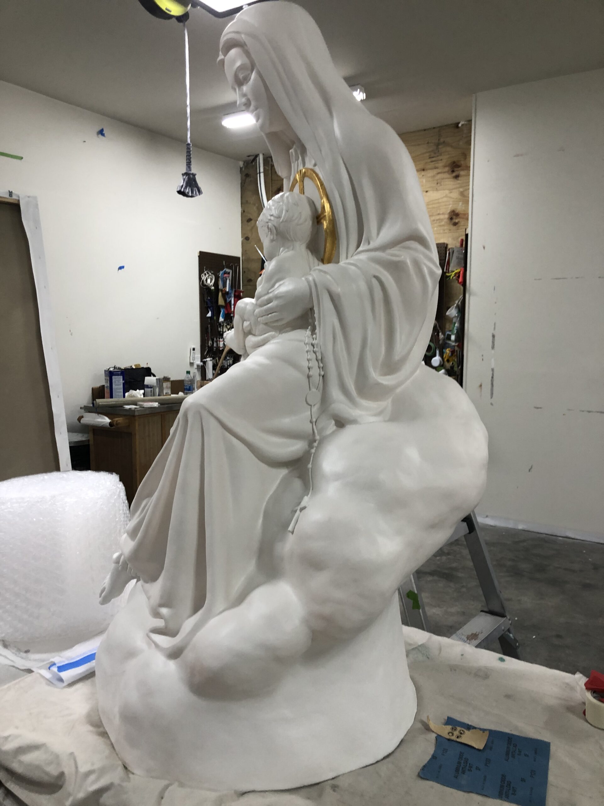 A statue of jesus is being painted in the process.