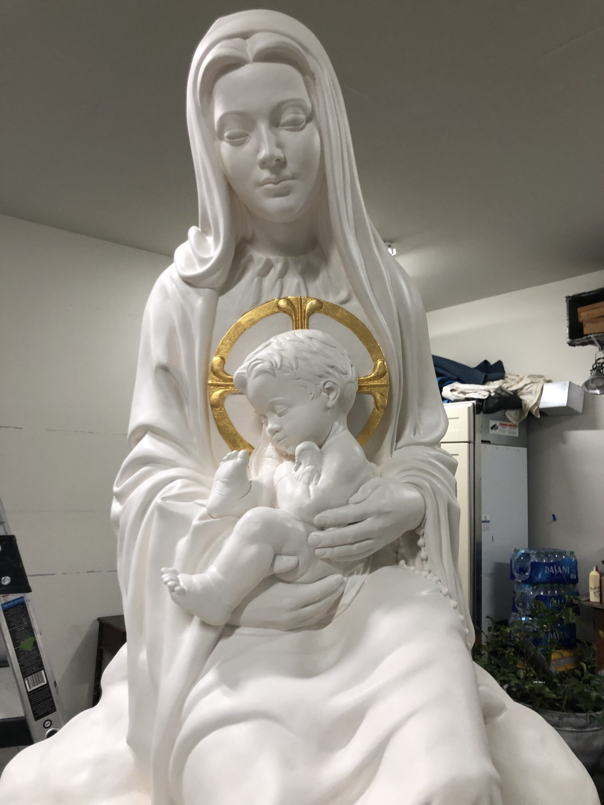 A statue of mary holding jesus in her arms.