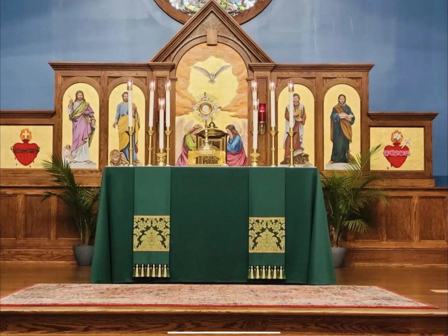 A church with green altar and pews in front of the alter.