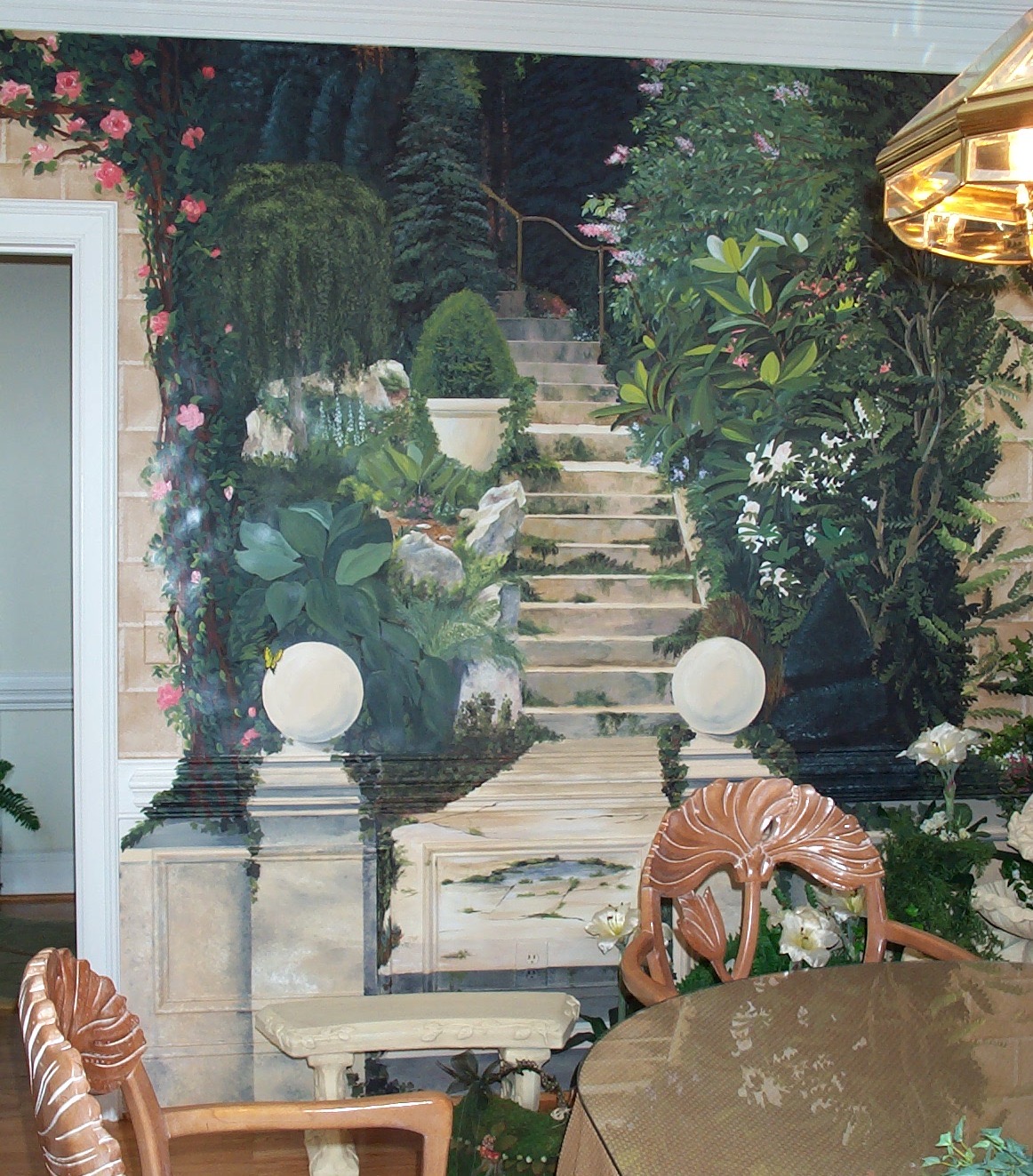 A dining room with a mural of stairs and plants.