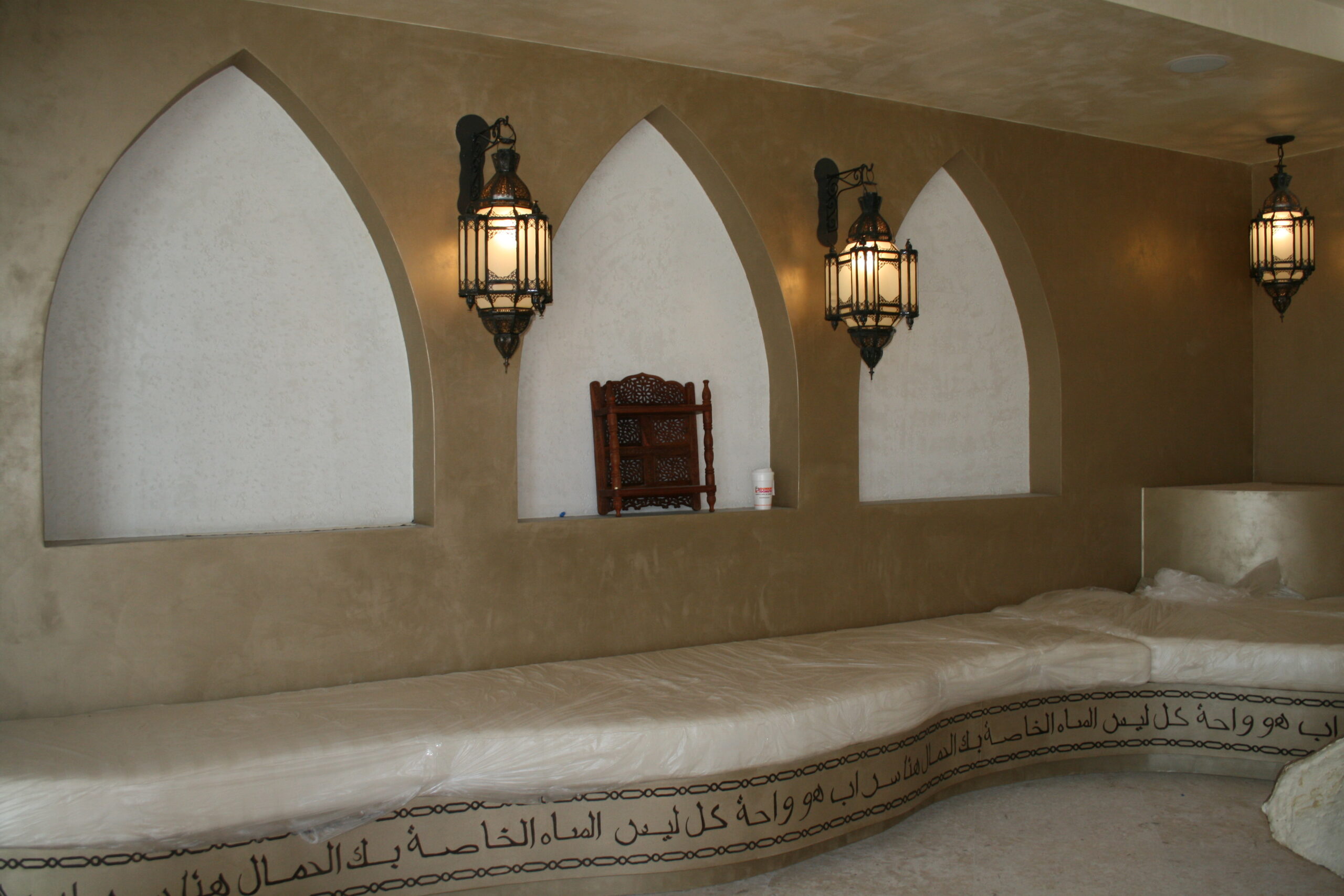 A room with three lamps and two benches