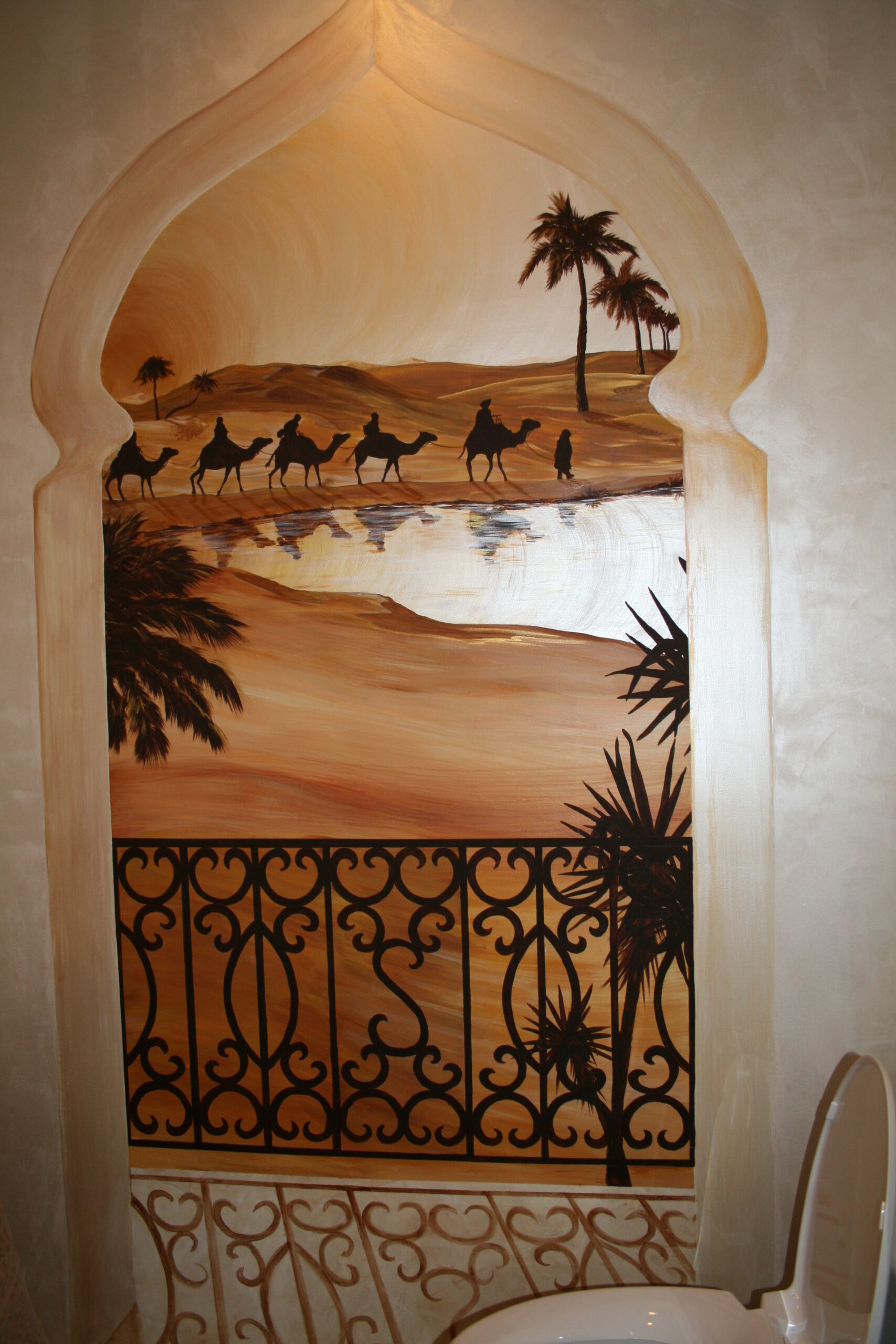 A painting of the desert with camels and palm trees.